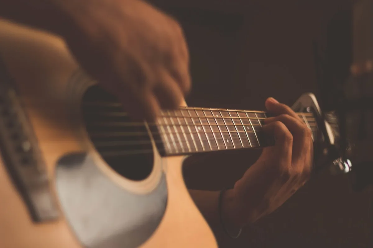 Músico a tocar guitarra num concerto